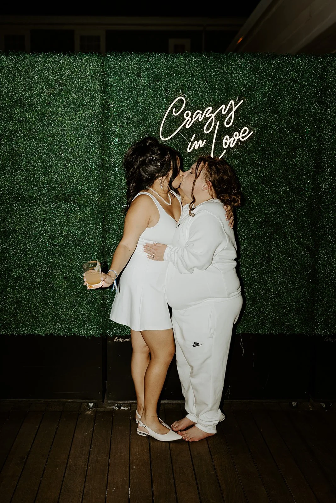 Two brides in wedding reception outfits