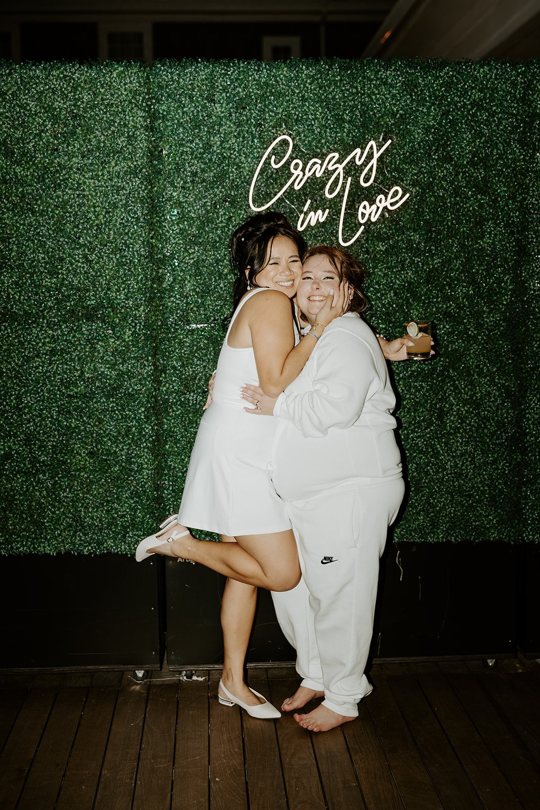 Two brides in wedding reception outfits