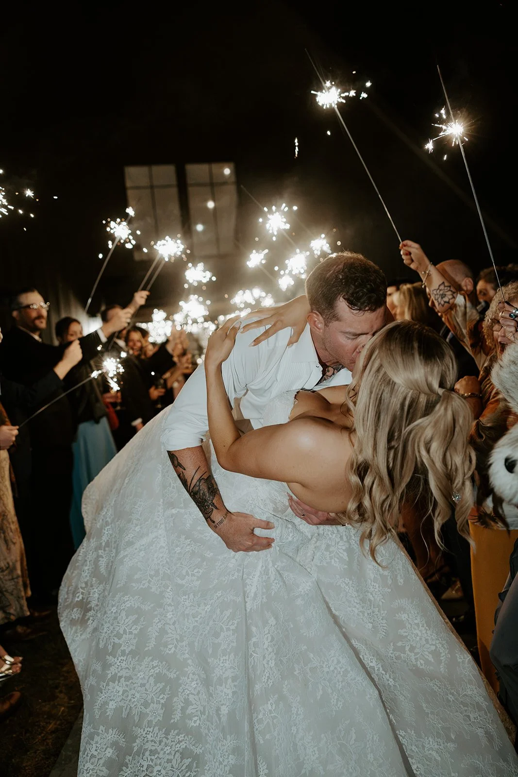 A bride and groom during a sparkler sendoff