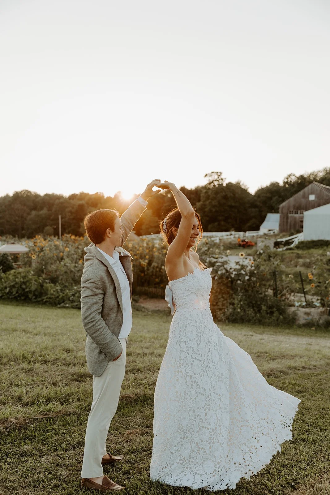A bride and groom taking sunset photos at their Maine wedding venue