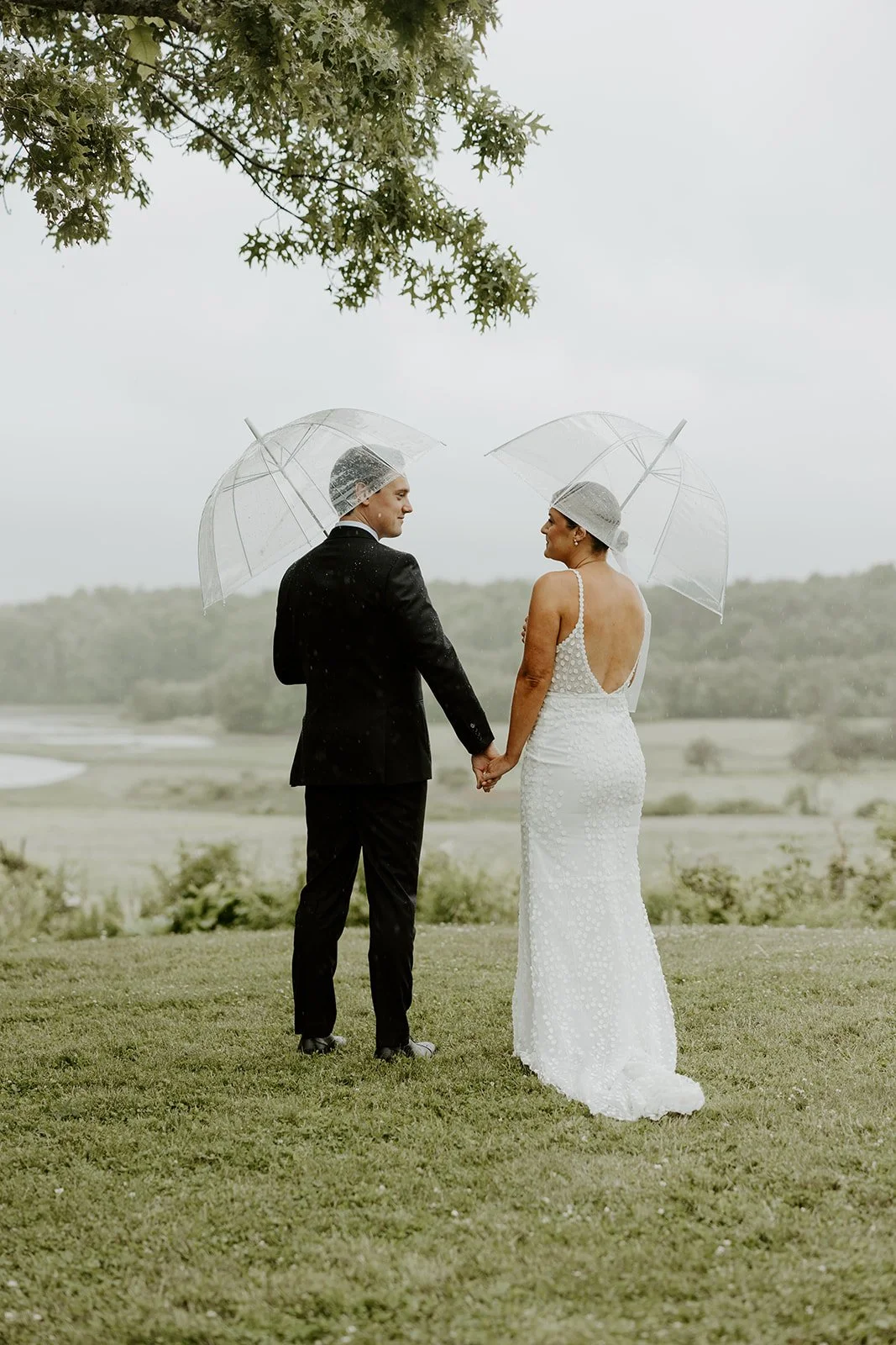 A bride and groom taking rainy wedding photos