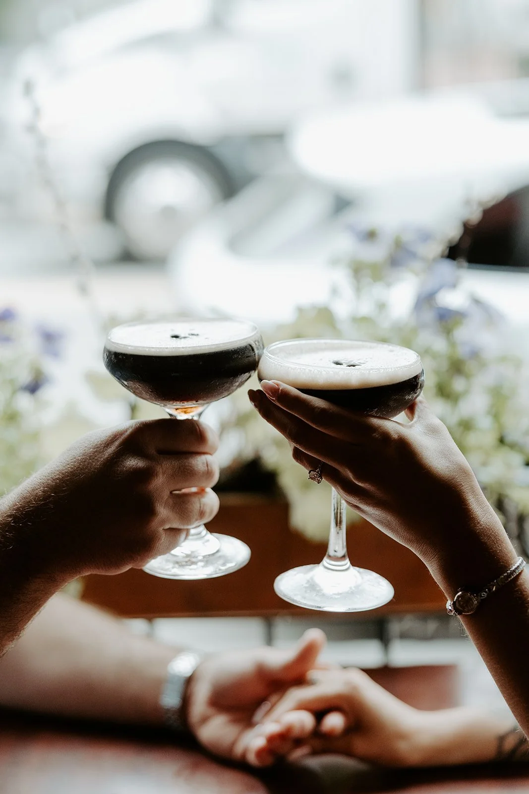 A couple having espresso martinis for date night engagement photos