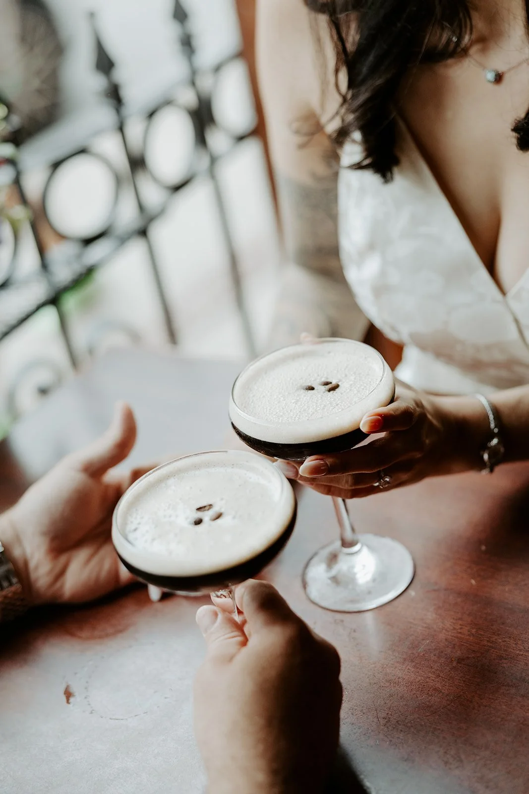 A couple having espresso martinis for date night engagement photos