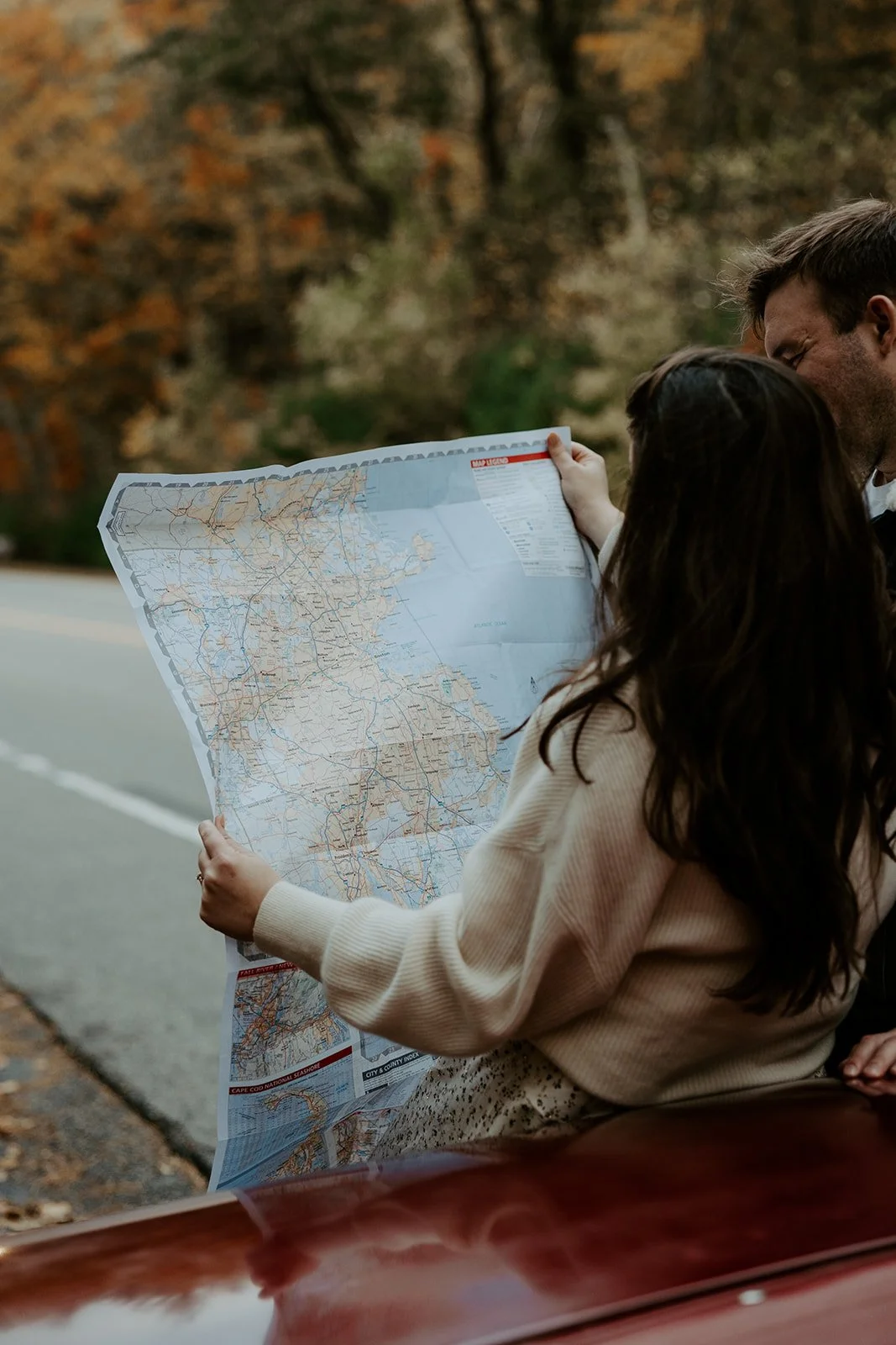 A couple taking vintage car engagement photos