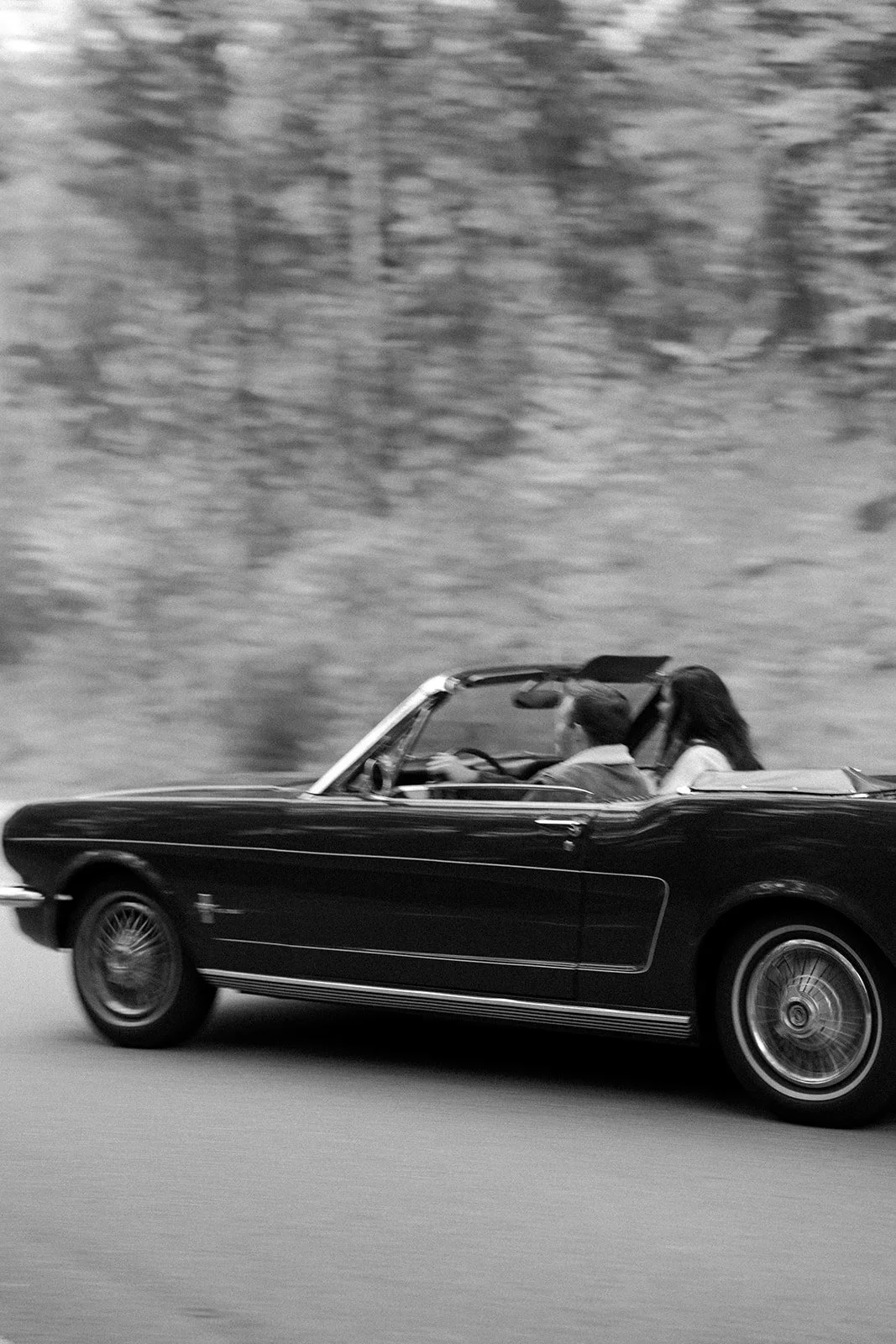 A couple driving during date night engagement photos