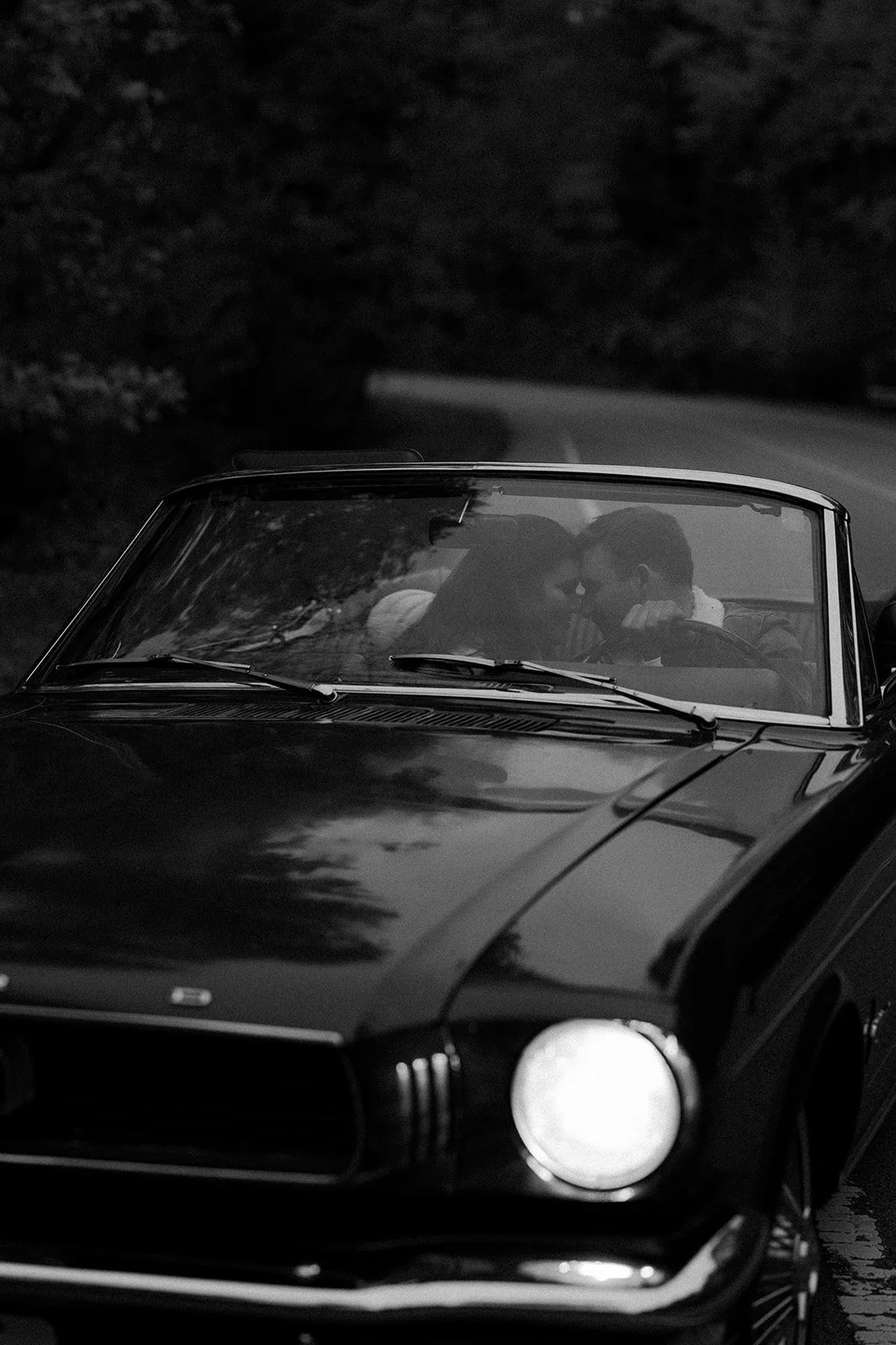 A couple driving during date night engagement photos