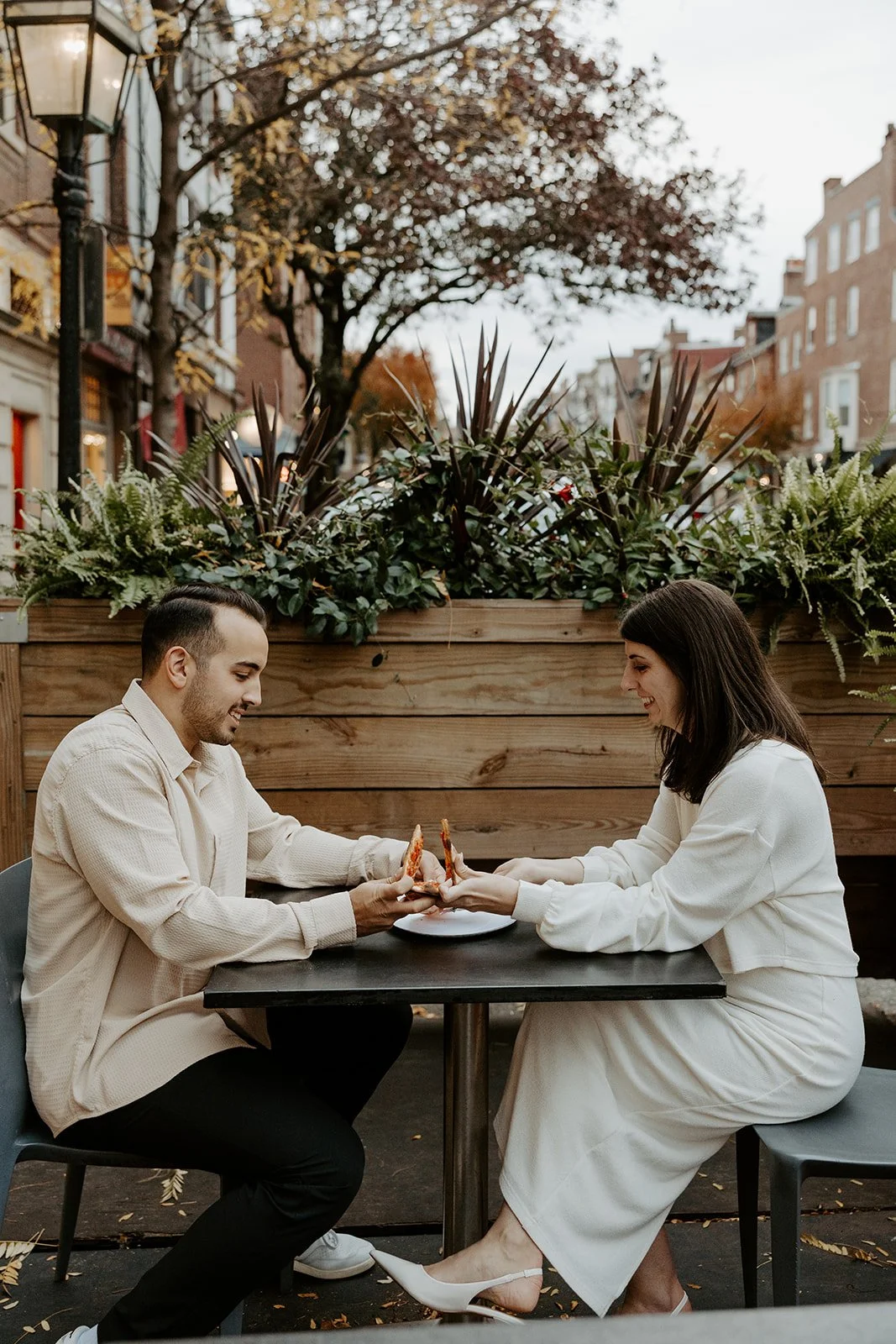 A couple eating pizza during engagement photos