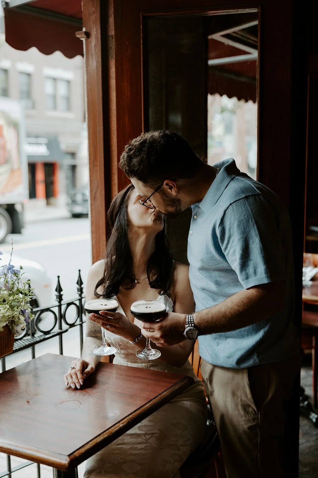 A couple taking bar engagement photos