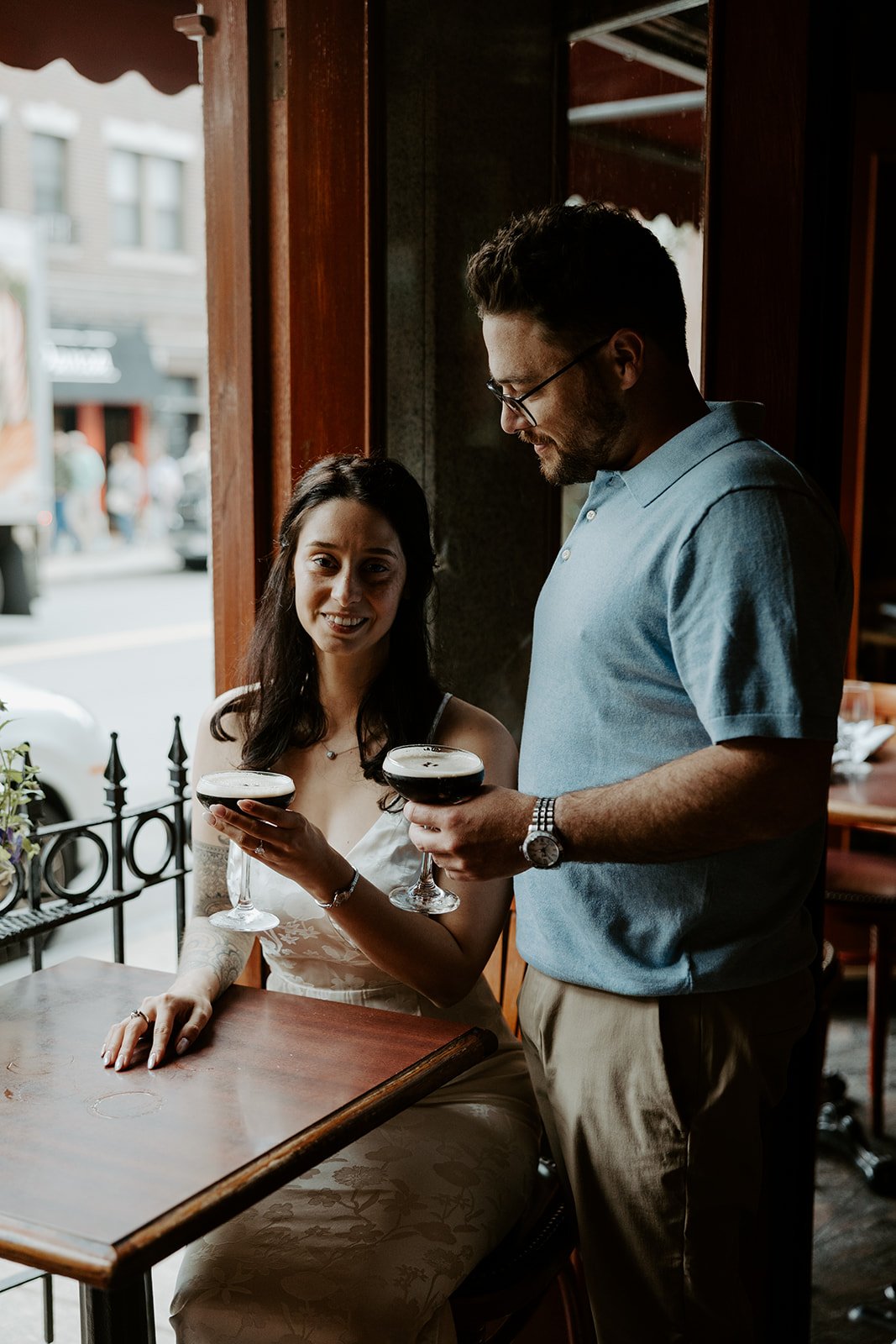A couple taking bar engagement photos