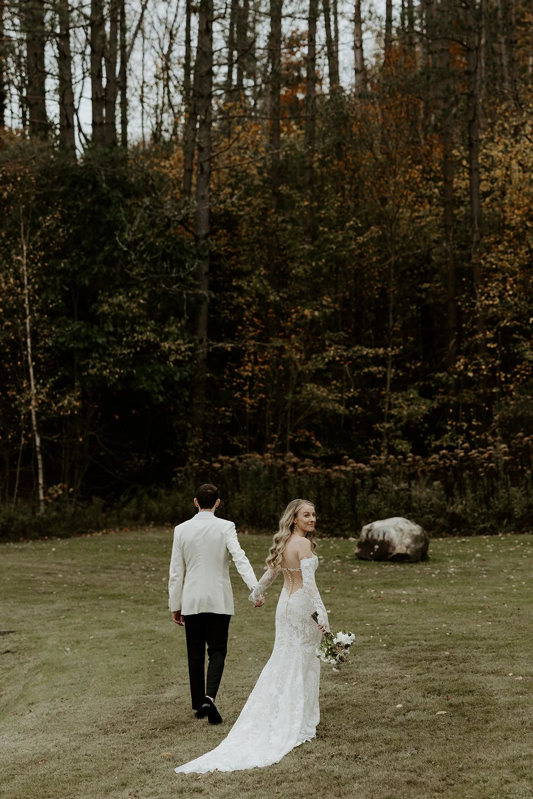 A couple walking through the woods at Farm Road Estate