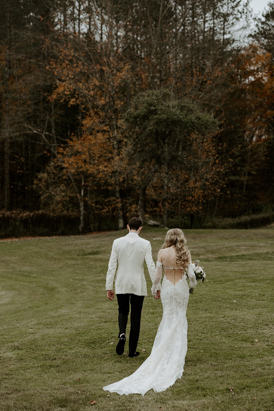 A couple walking through the woods at Farm Road Estate