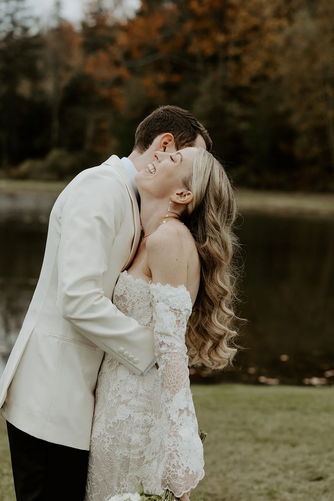 A bride and groom taking fall wedding photos