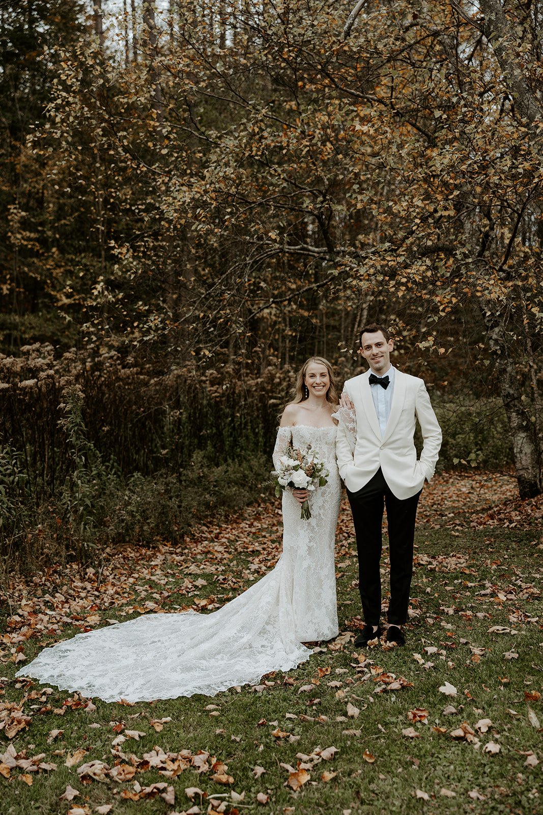 A bride and groom taking fall wedding photos