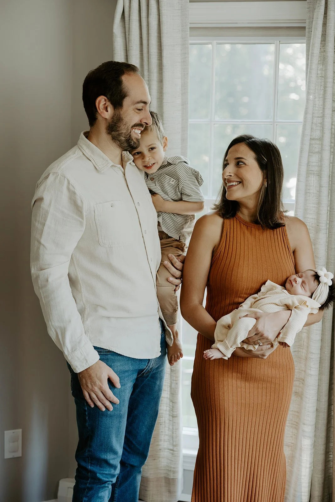 A family taking newborn photos with a Boston newborn photographer
