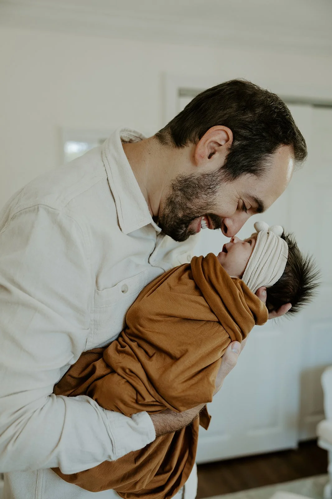 A dad with his newborn baby, by a Boston newborn photographer
