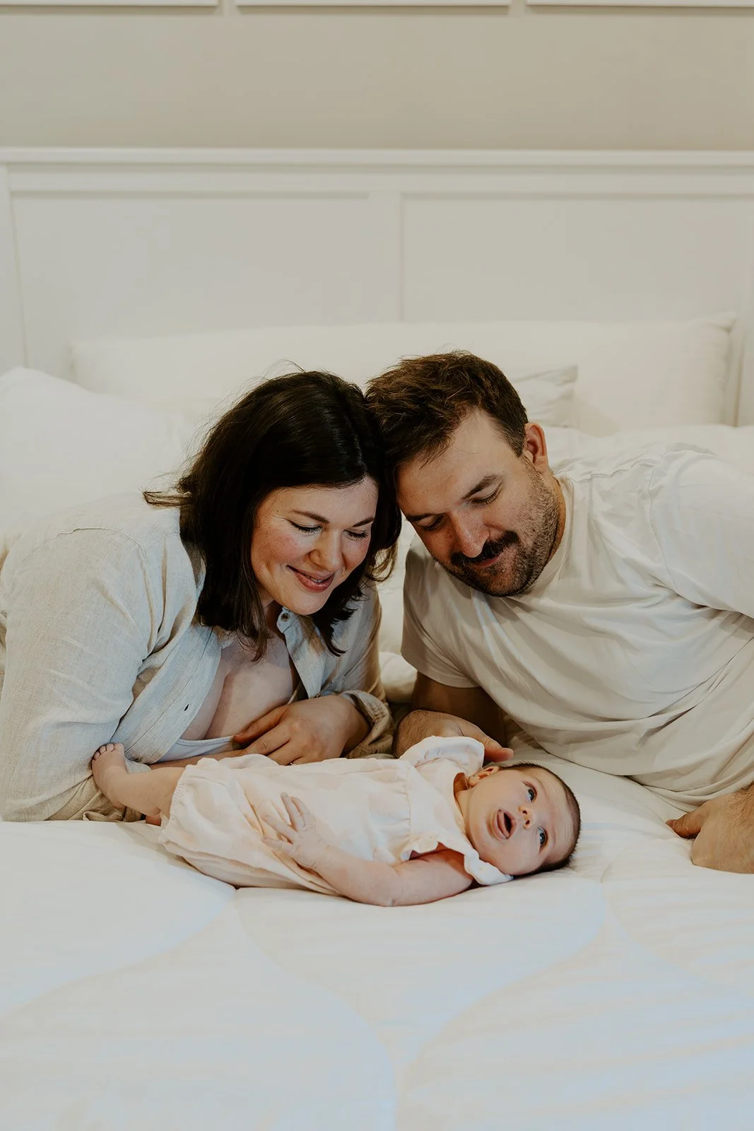 A family taking newborn photos with their Boston newborn photographer