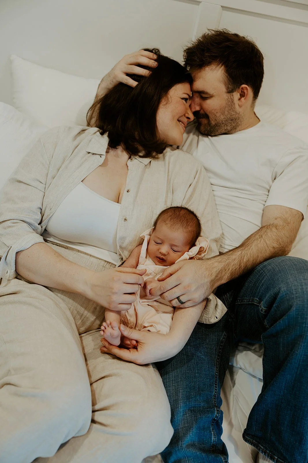 A family taking newborn photos with their Boston newborn photographer