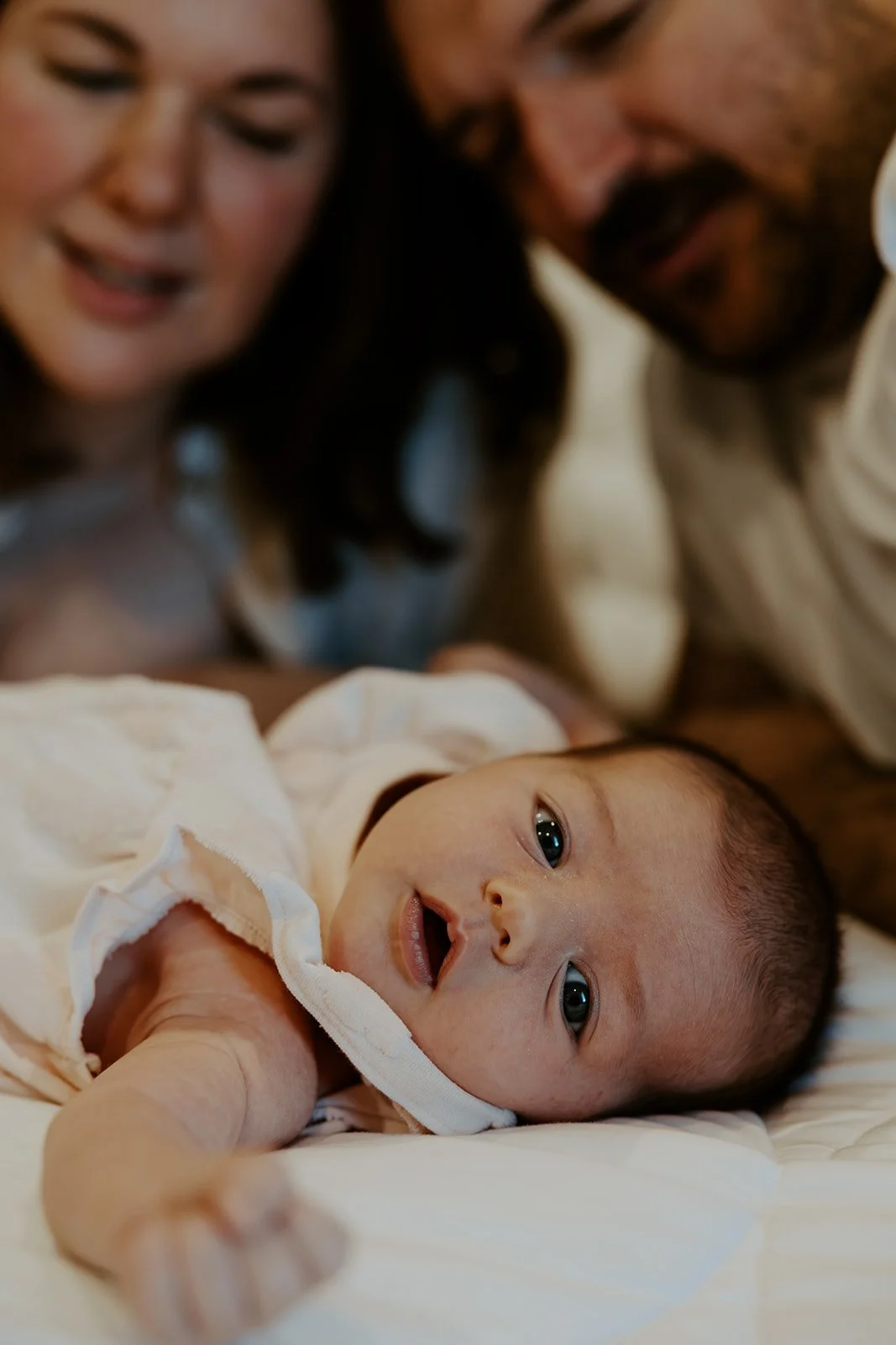 A family taking newborn photos with their Boston newborn photographer
