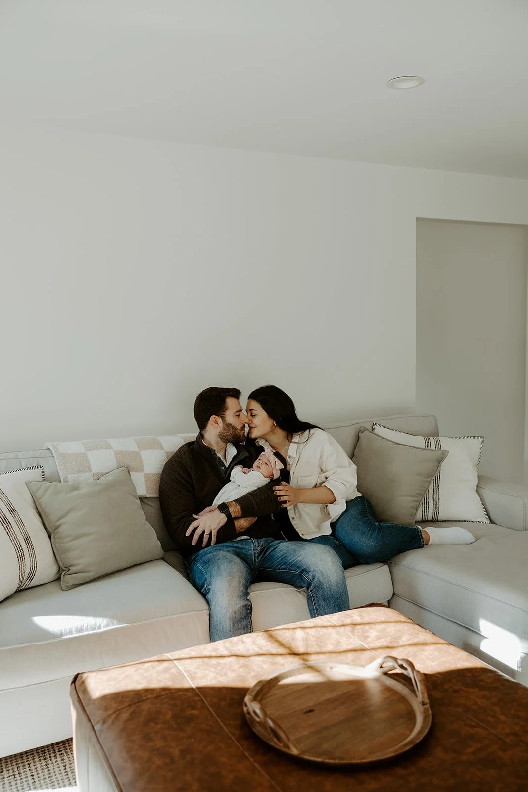 A family on their couch during newborn photos
