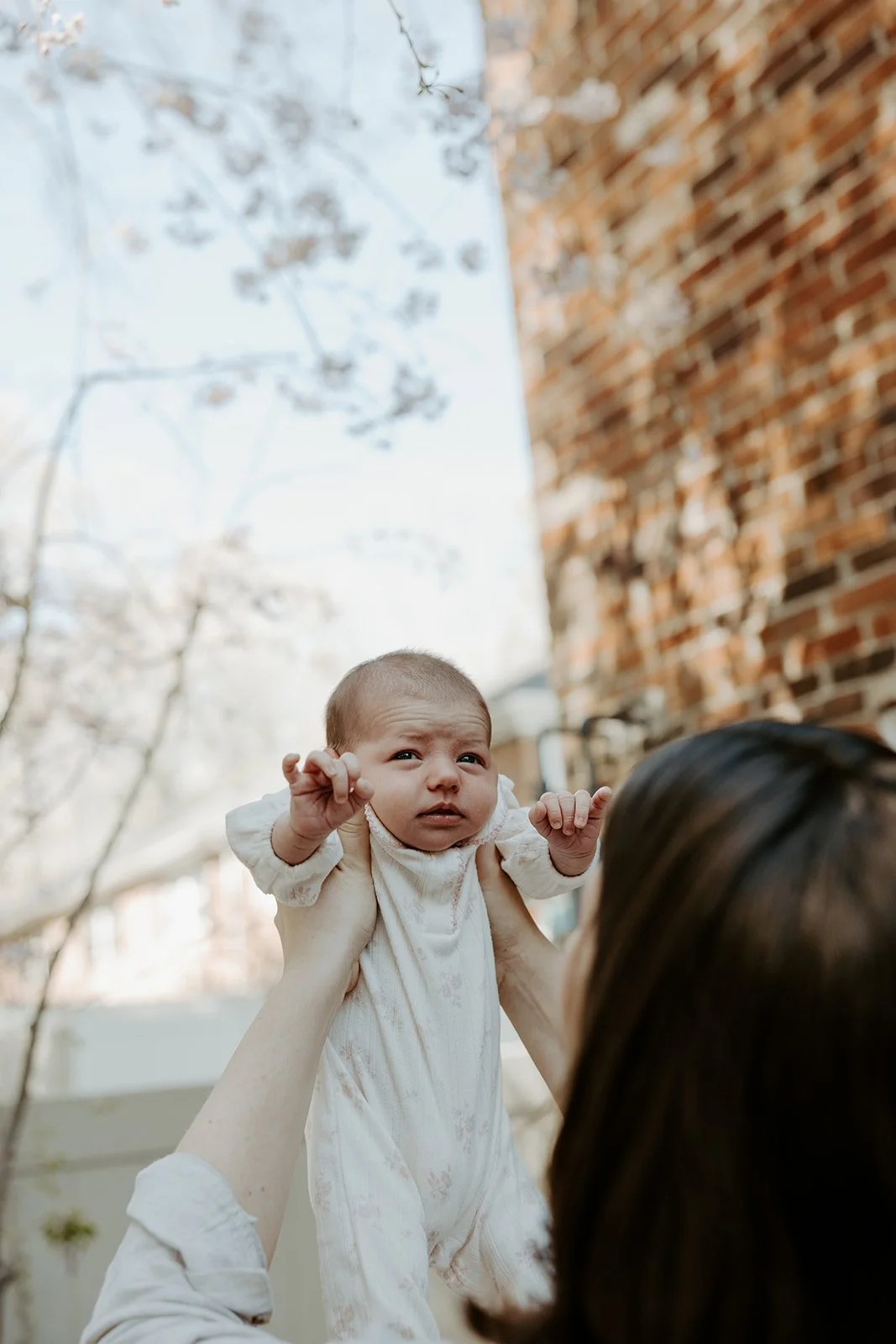 A newborn baby outside during a photoshoot
