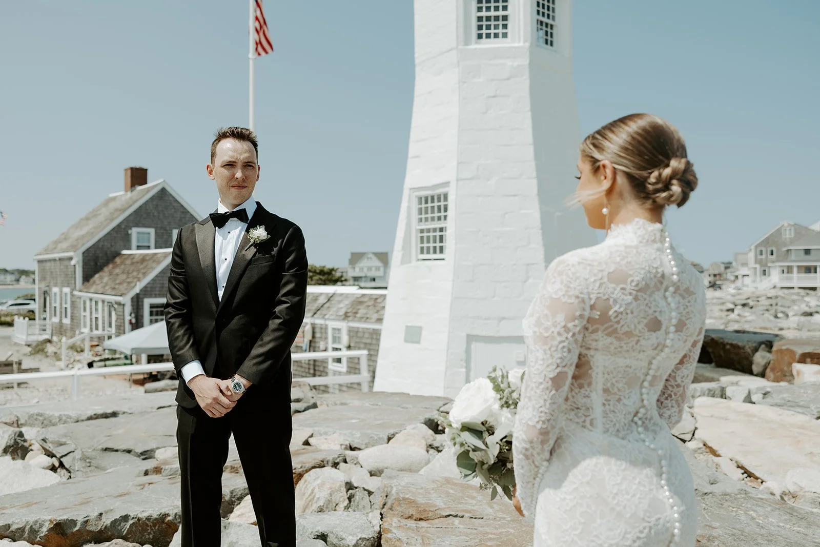 A bride and groom at a lighthouse
