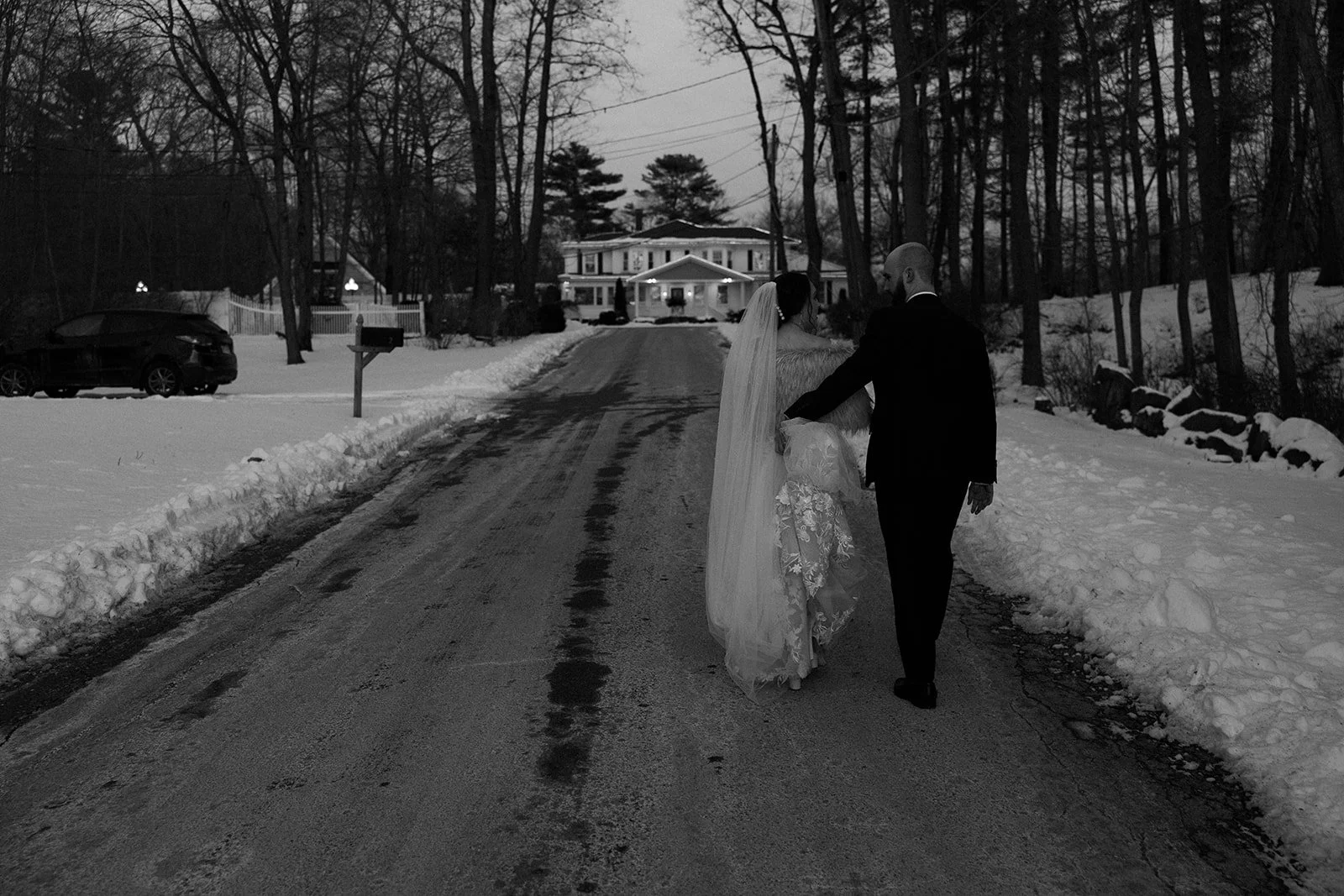 A bride and groom walking towards their wedding venue at their off season wedding