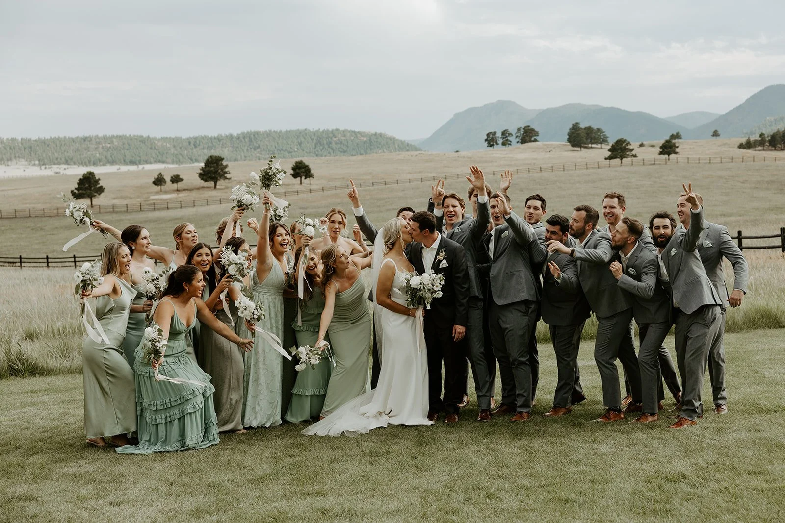 A wedding party cheering for a bride and groom