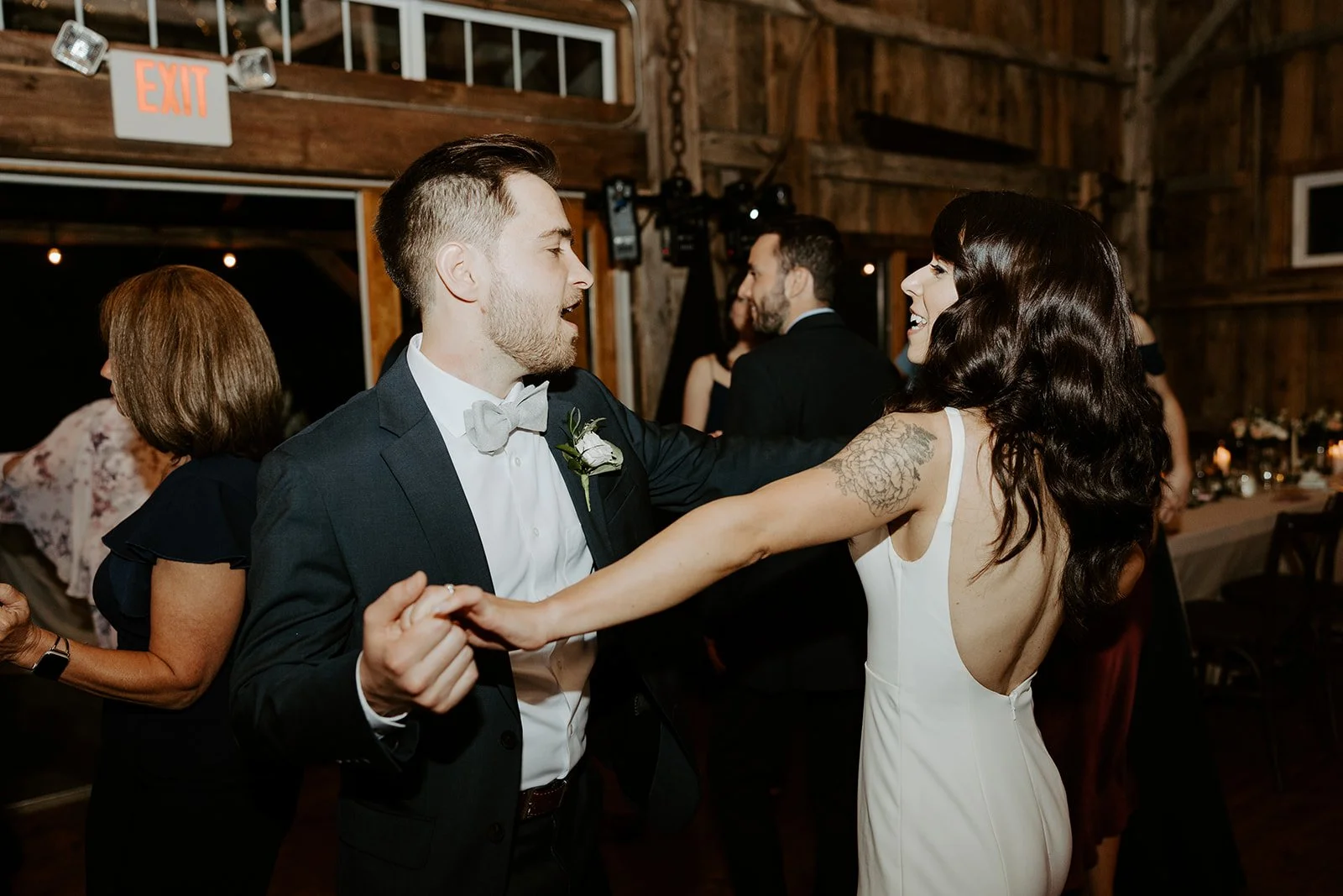 A bride and groom dancing at their wedding reception in a candid wedding photo