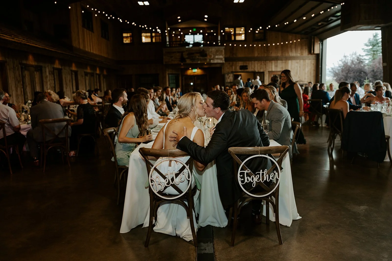 A bride and groom kissing at their wedding reception