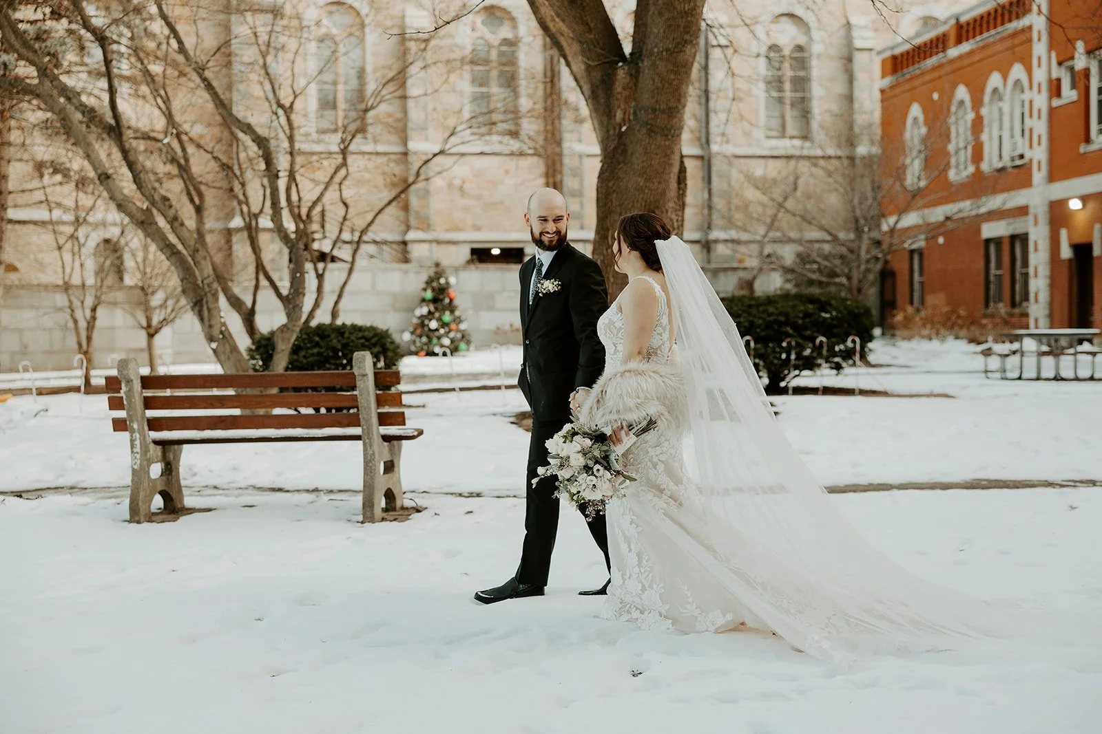 A bride and groom taking snowy wedding photos