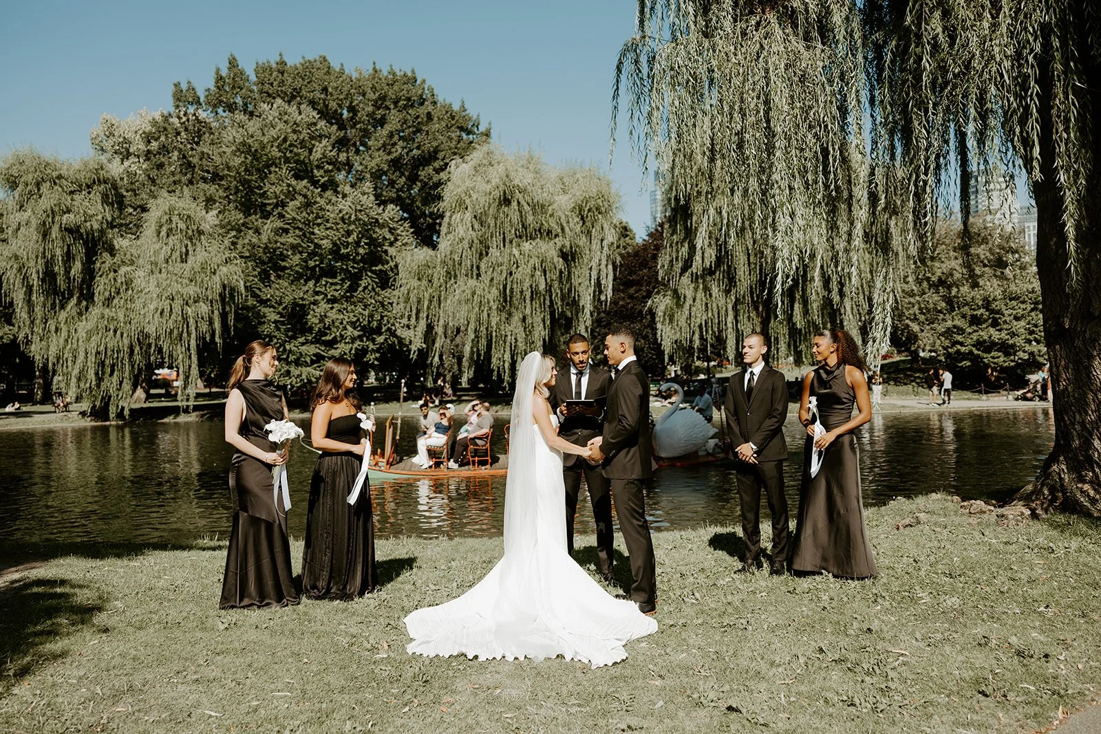 A wedding ceremony taking place at Lagoon Edge in Boston Public Garden