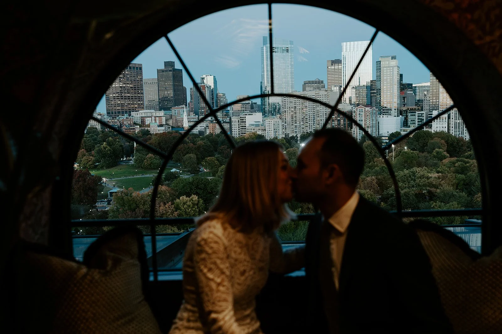 A bride and groom kissing at a Boston wedding reception