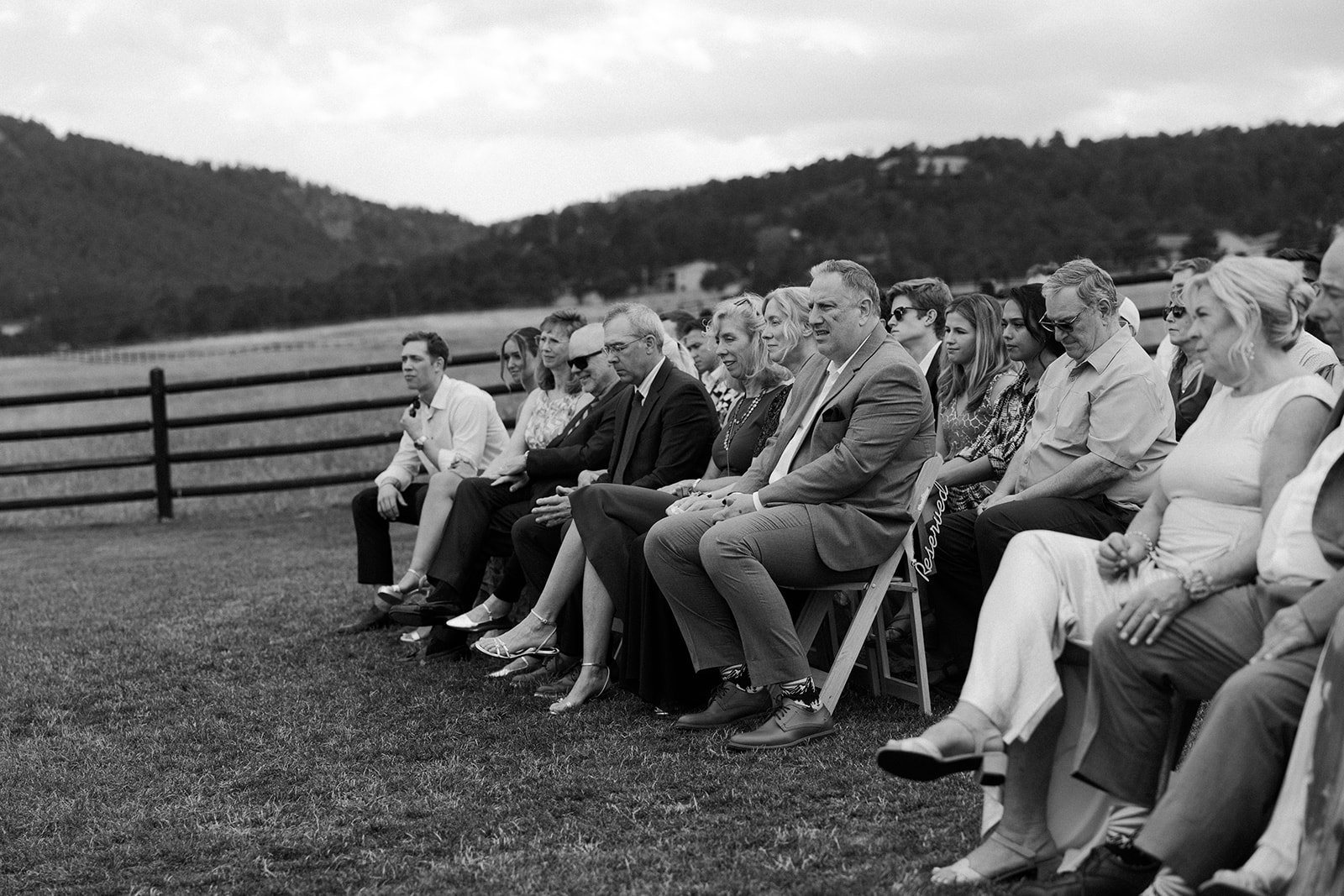 A black and white image of wedding guests at a ceremony