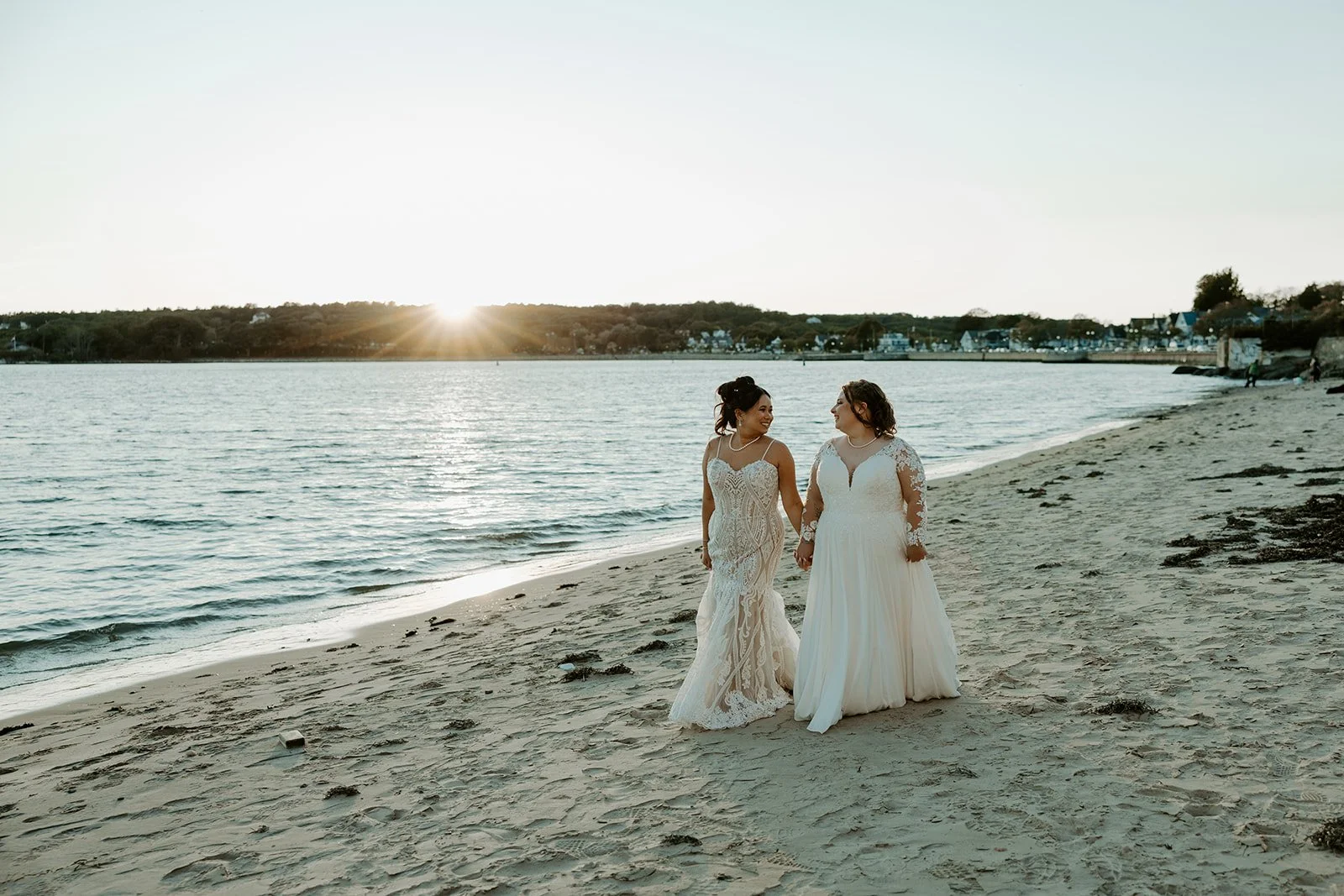Two brides walking on the beach