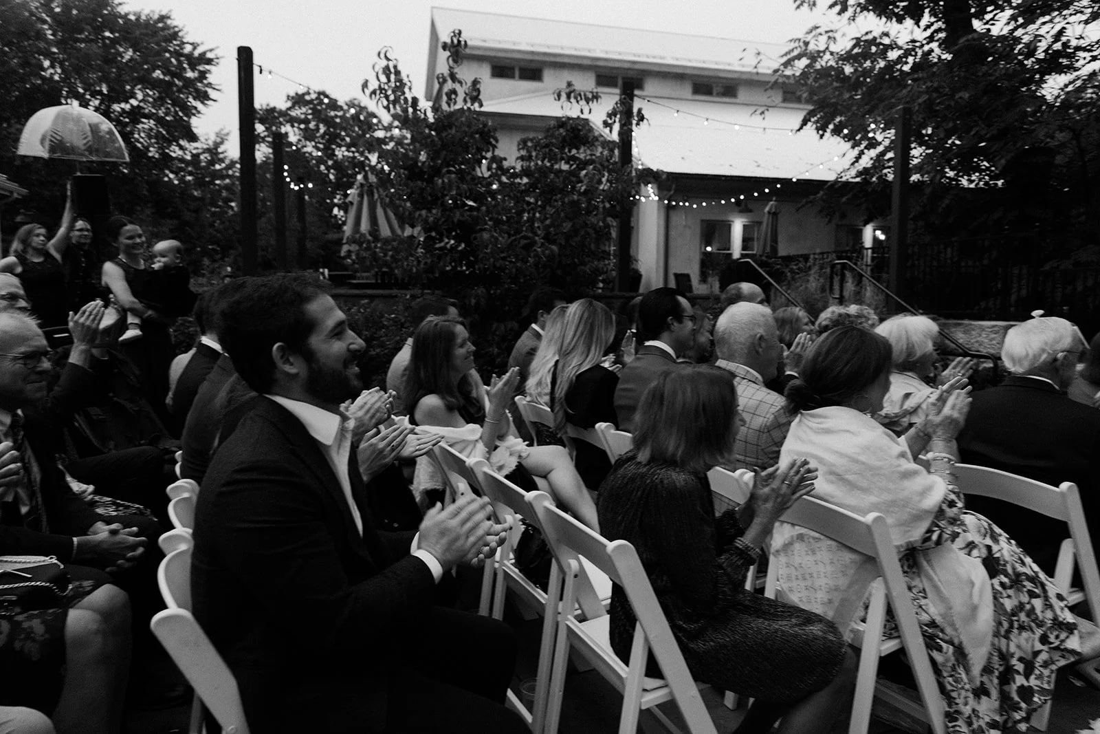 Wedding guests clapping at a wedding ceremony