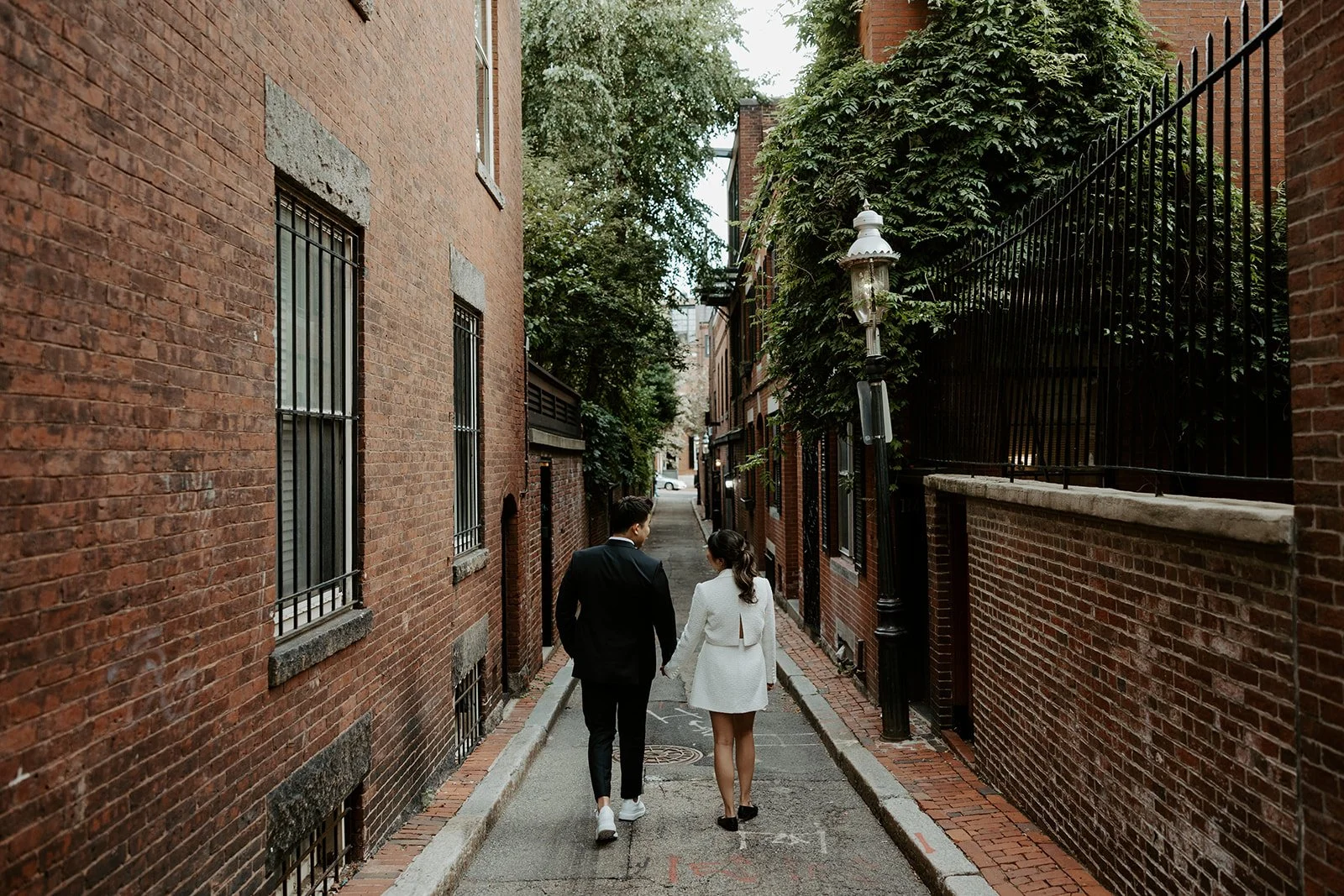 A couple walking through Beacon Hill for engagement photos