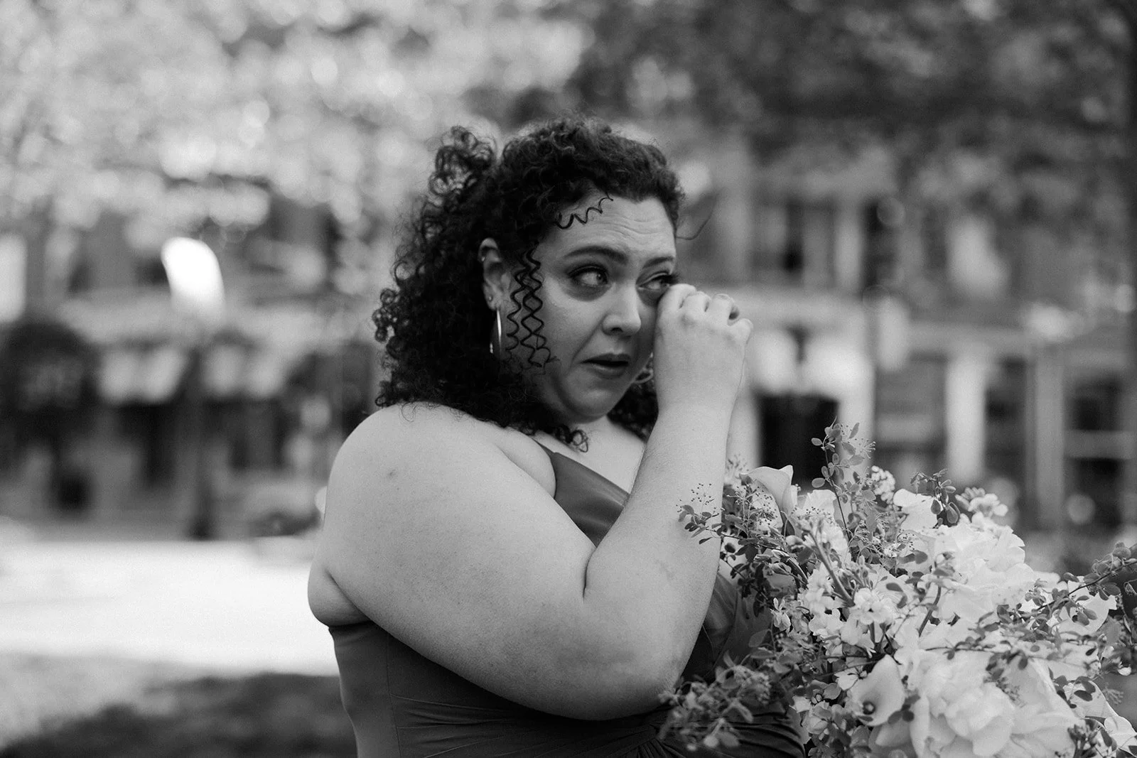 An elopement guest crying outside at a Boston elopement location, the Greenway