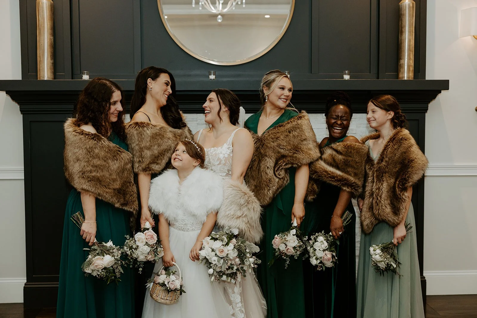Bridesmaids wearing fur shawls at a winter wedding