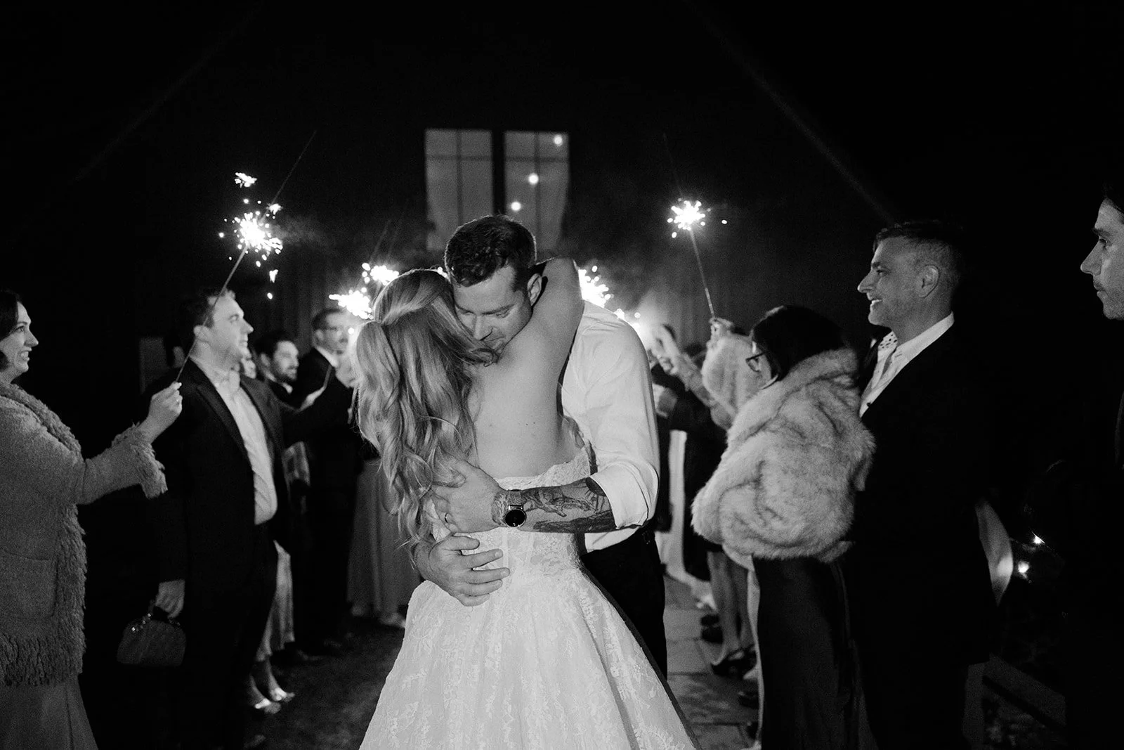 A bride and groom during a sparkler sendoff