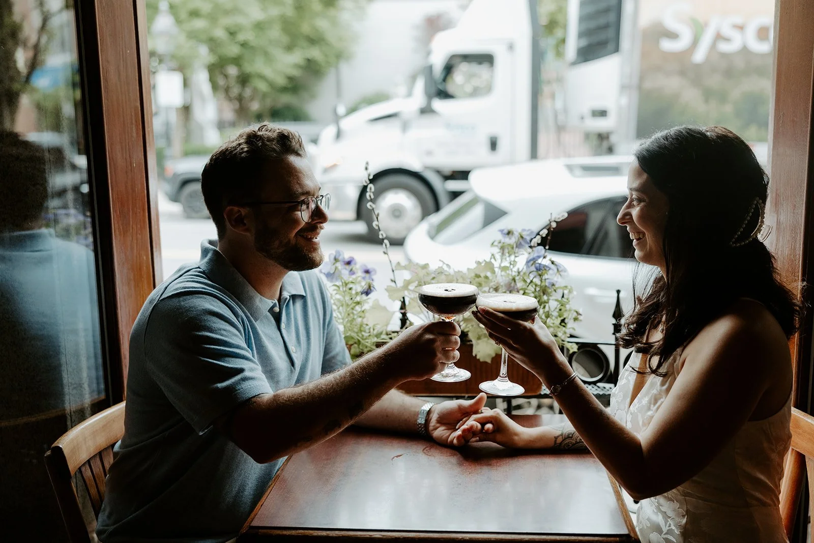 A couple taking bar engagement photos