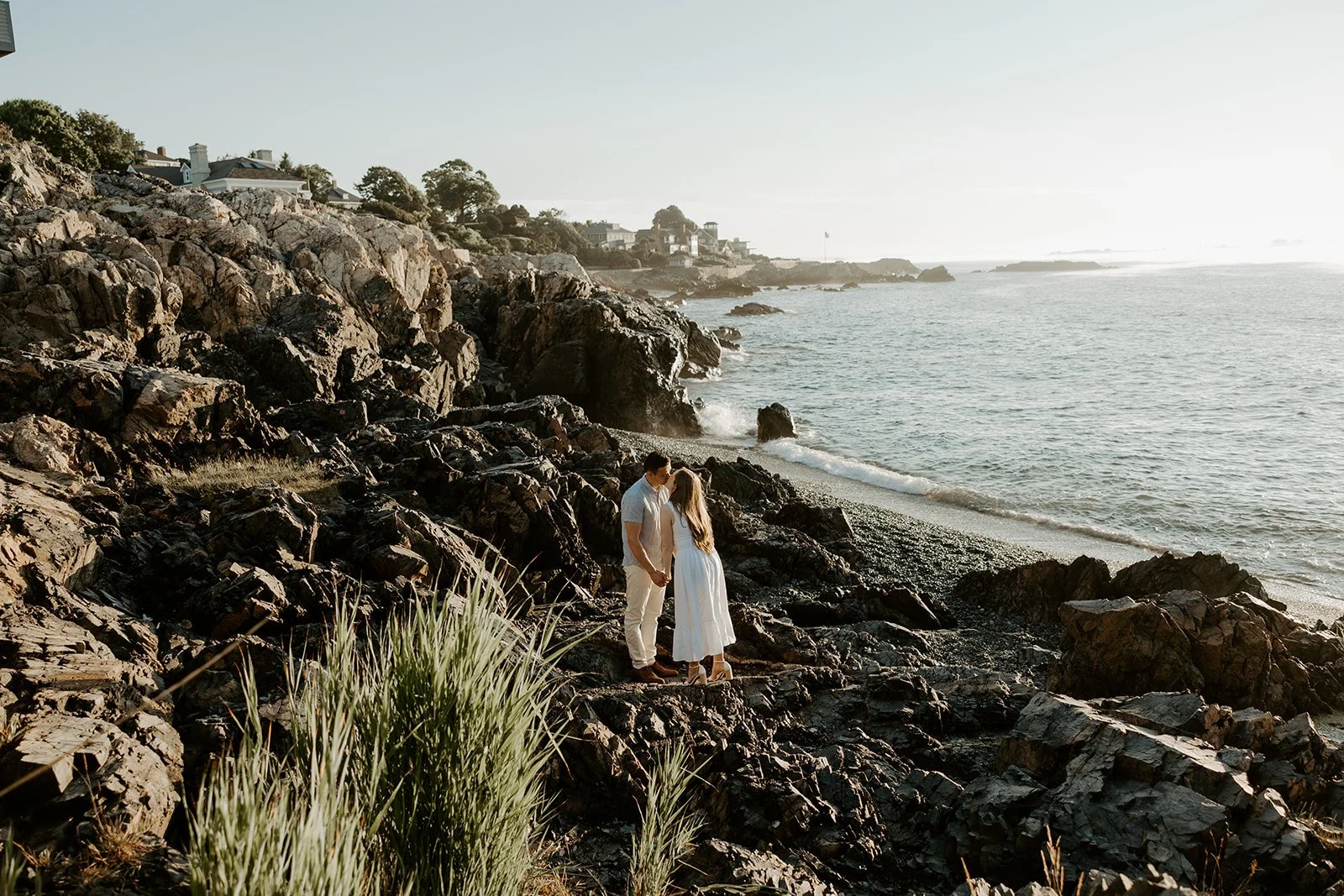 A couple kissing during their beach engagement photos at a Massachusetts engagement photo location