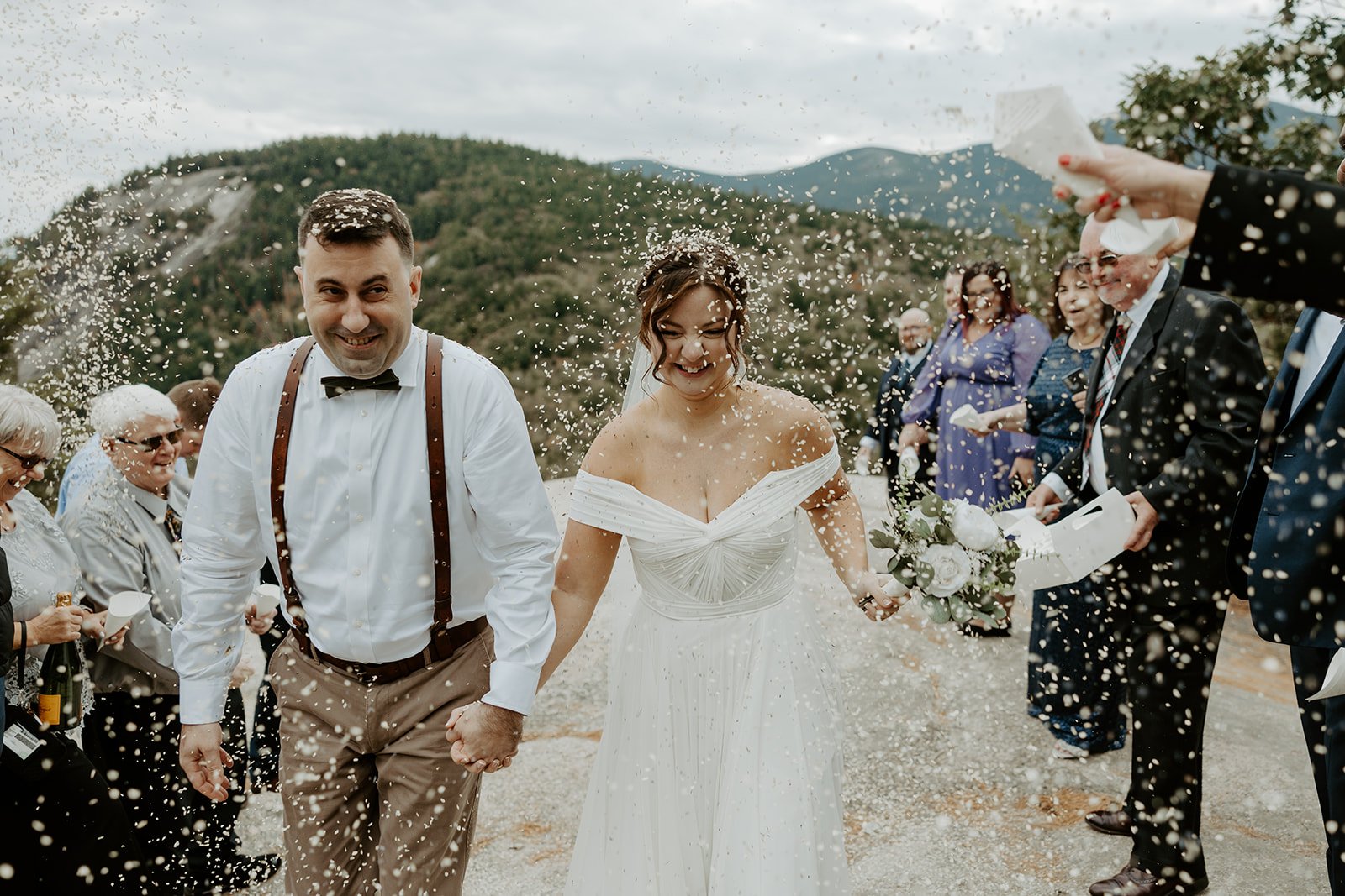 A bride and groom exiting their mountain elopement