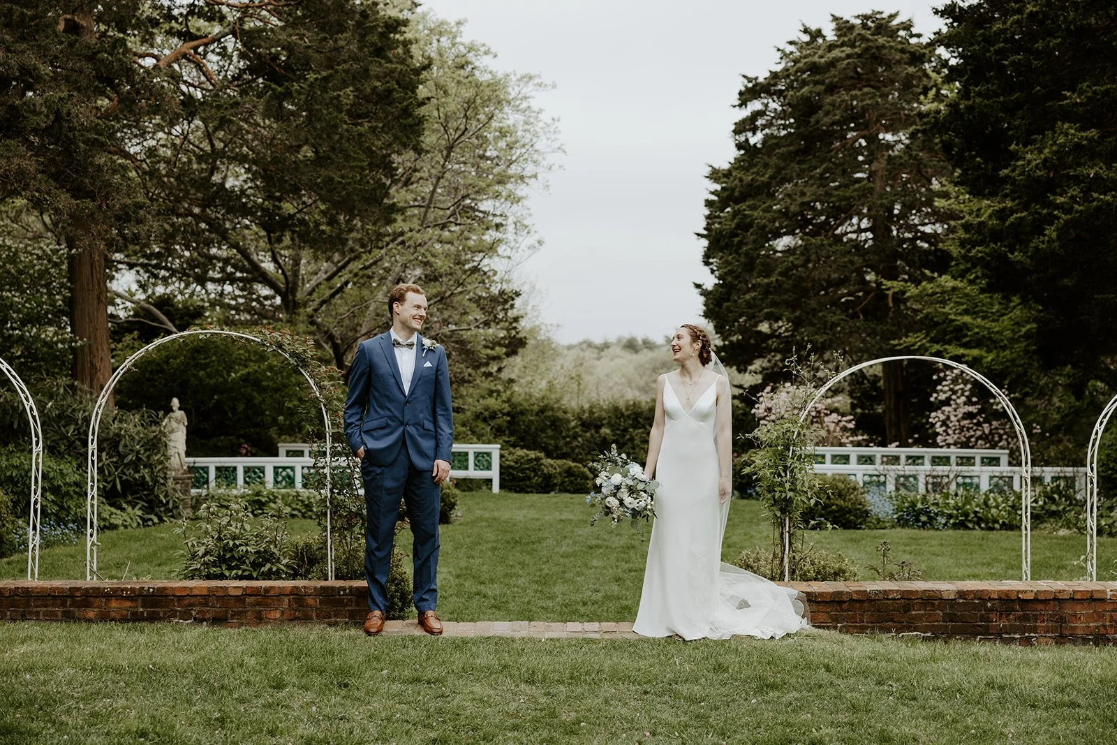 A bride and groom taking outdoor wedding photos
