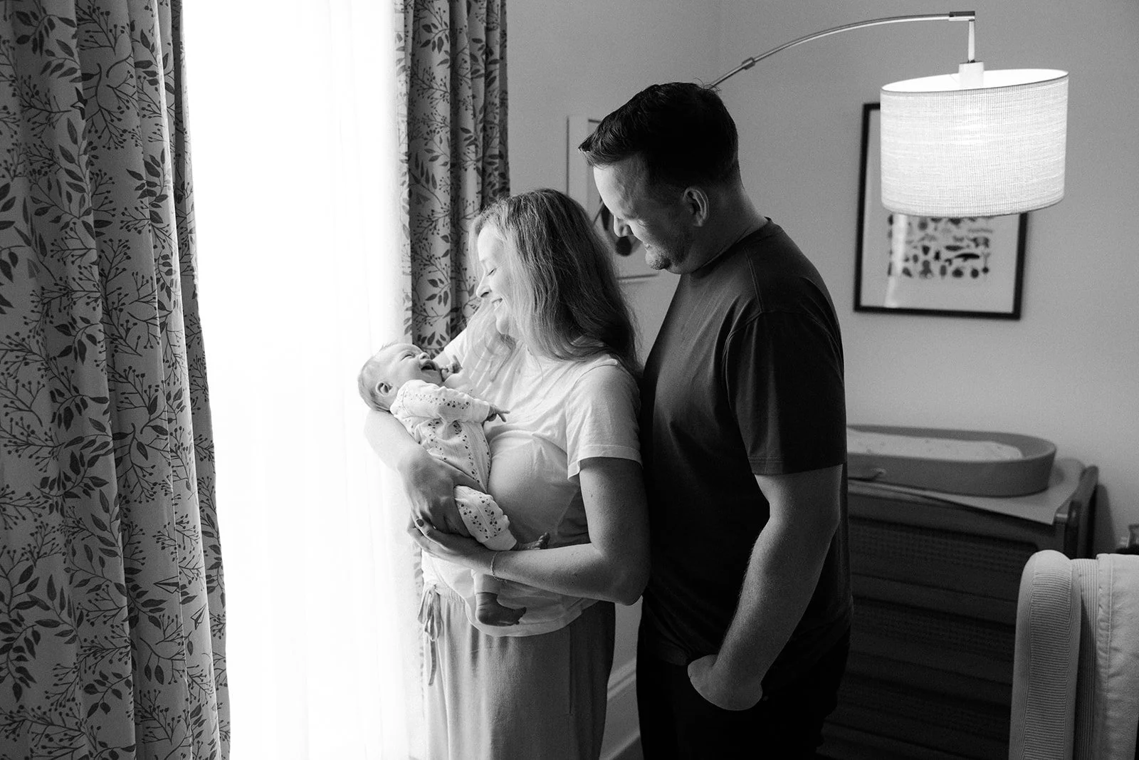 A family taking newborn photos with a Boston newborn photographer