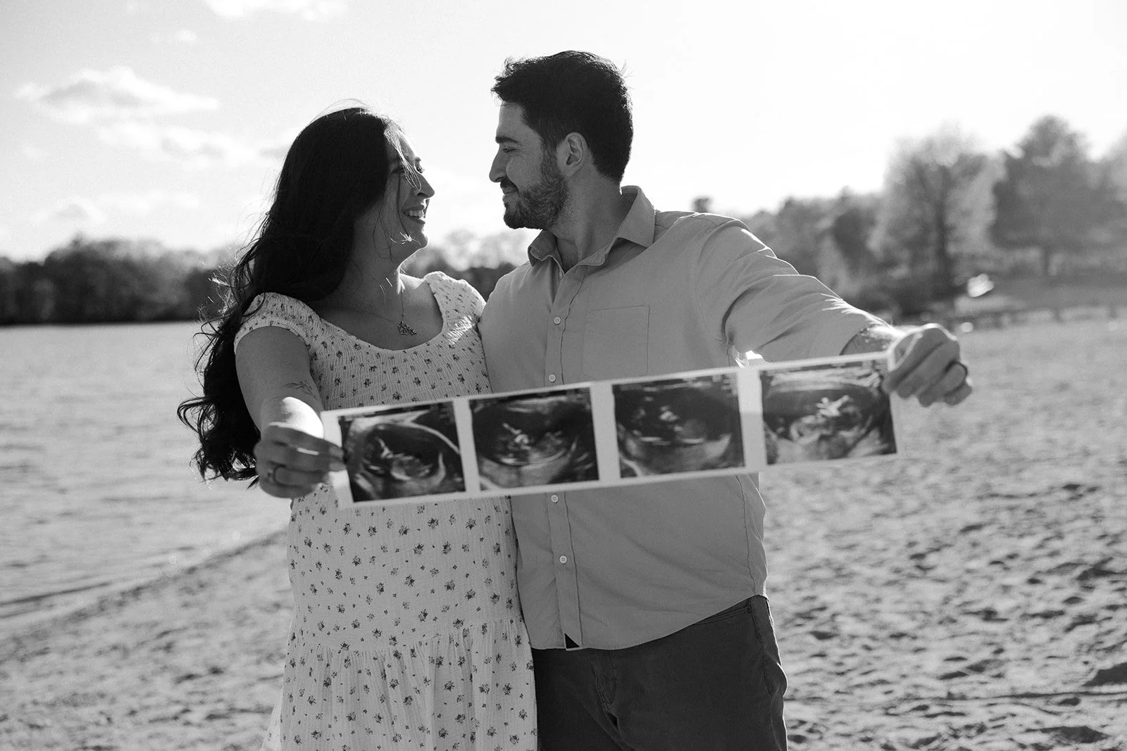 A couple posing for maternity photos