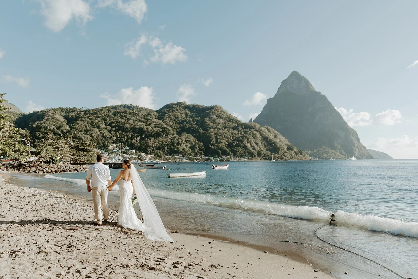 A couple walking on the beach in St Lucia, their destination wedding location