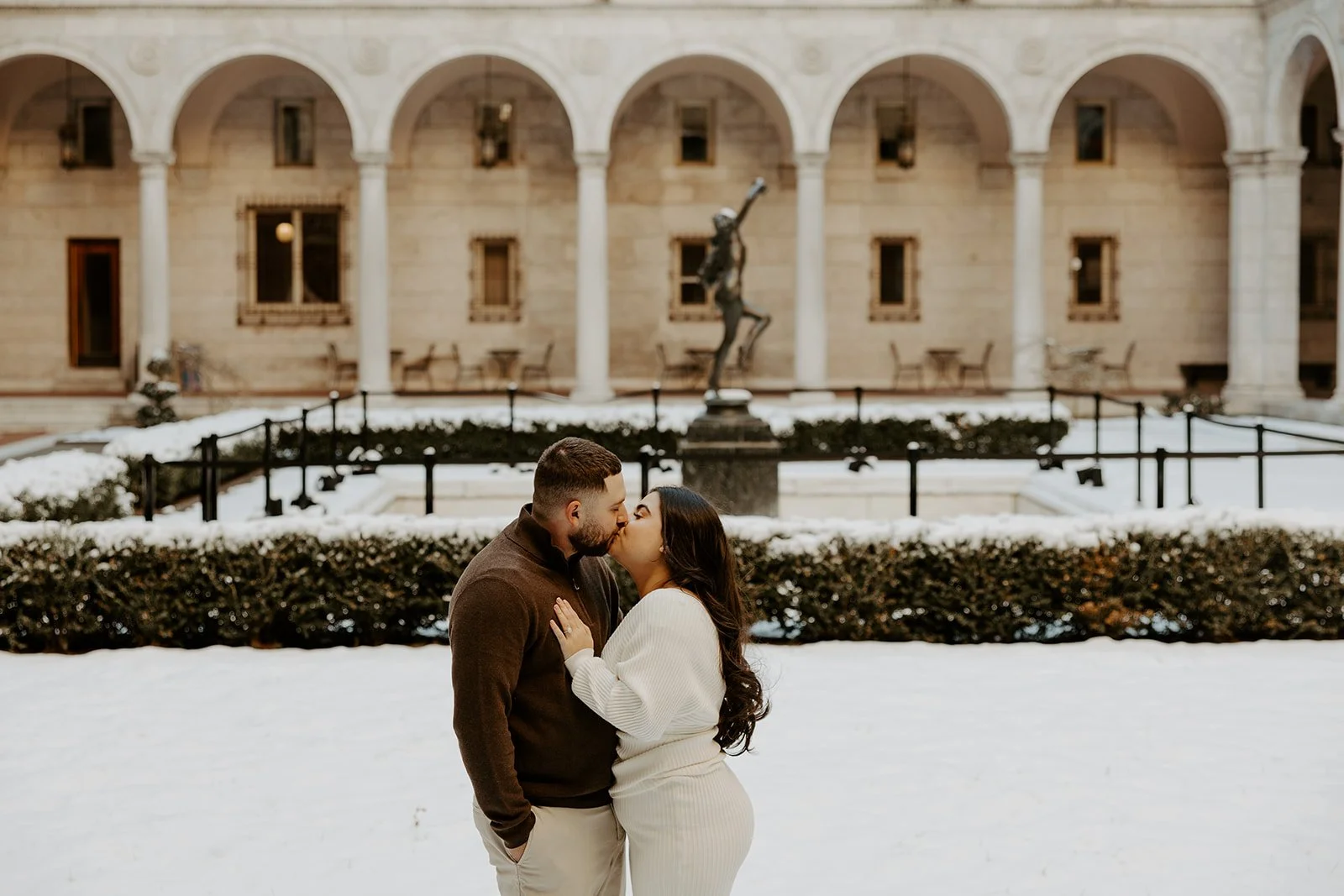 A couple taking winter engagement photos in Boston