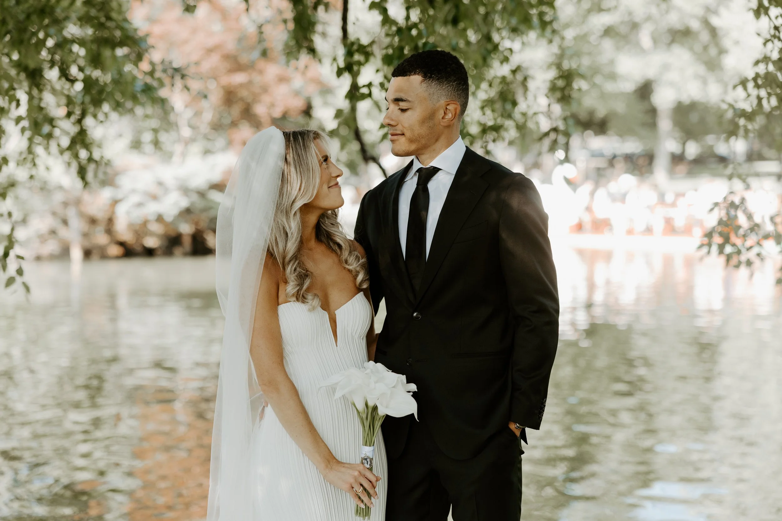A couple posing for elopement photos in Boston Public Garden