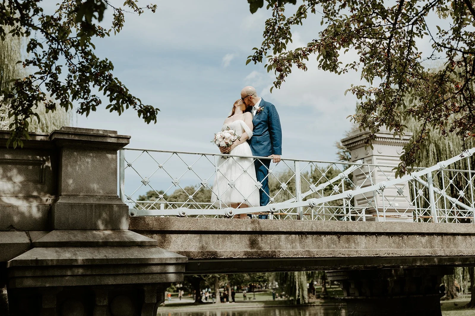 A bride and groom on the bridge in Boston Public Garden