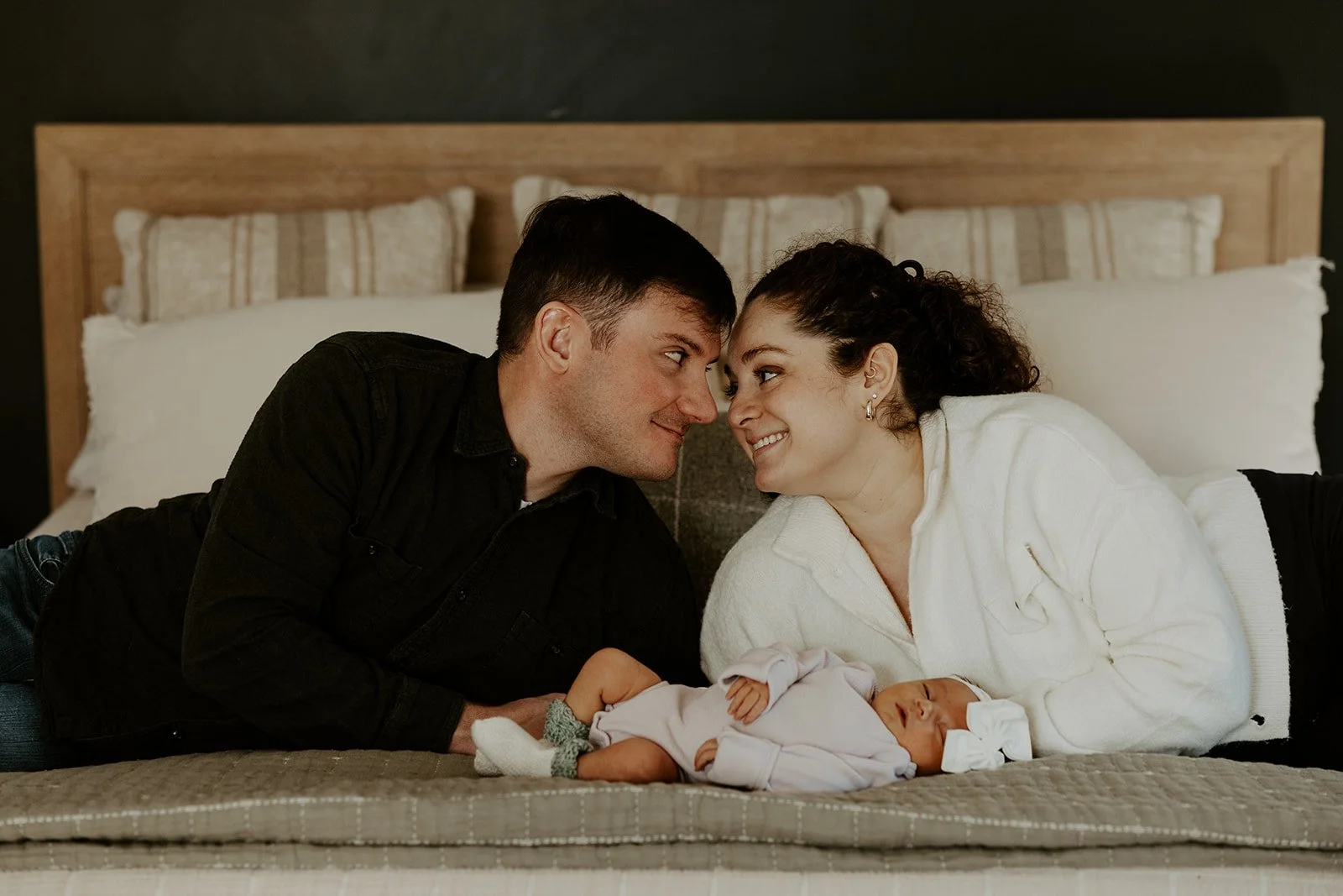 A family taking newborn photos with a Boston newborn photographer